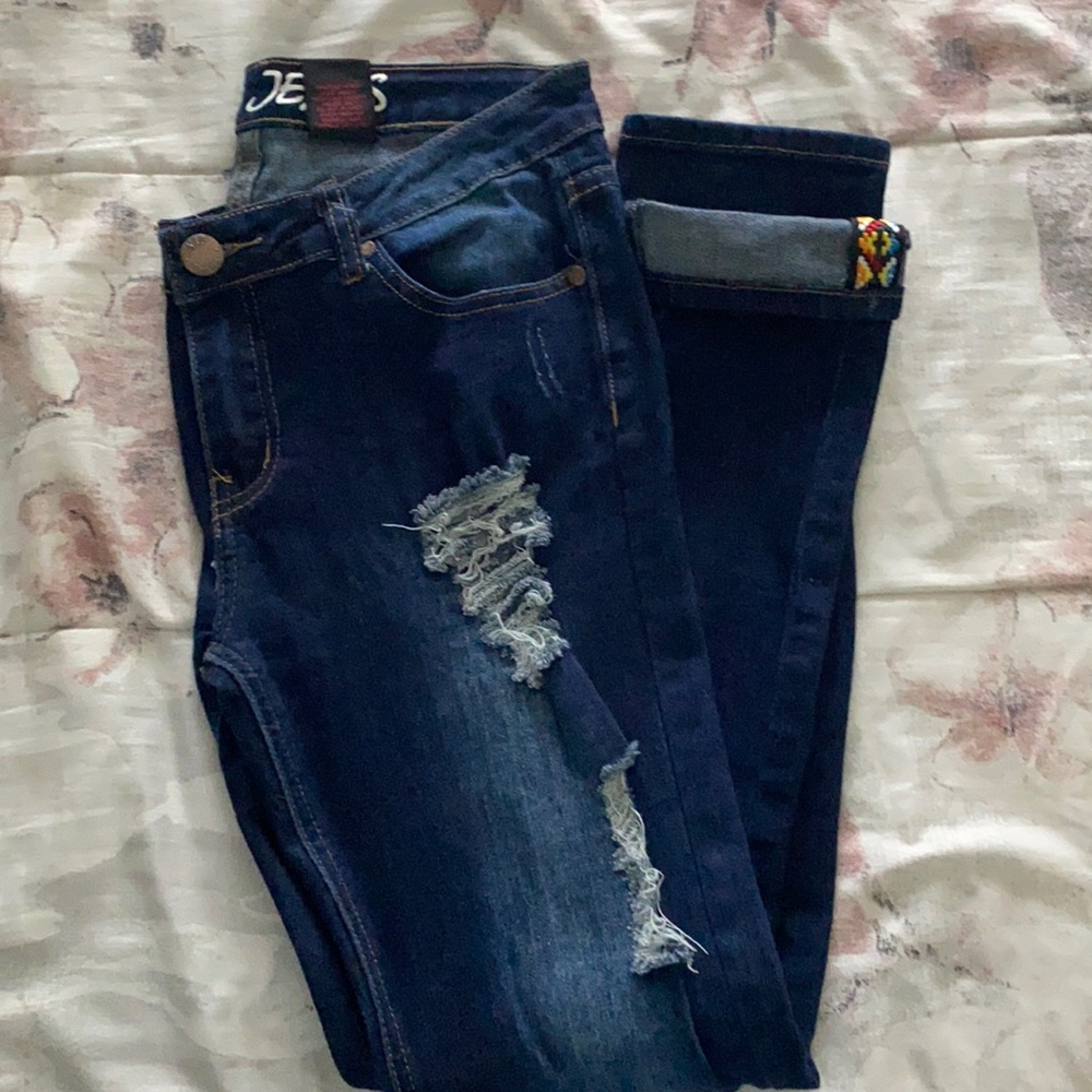 Dark blue ripped jeans.